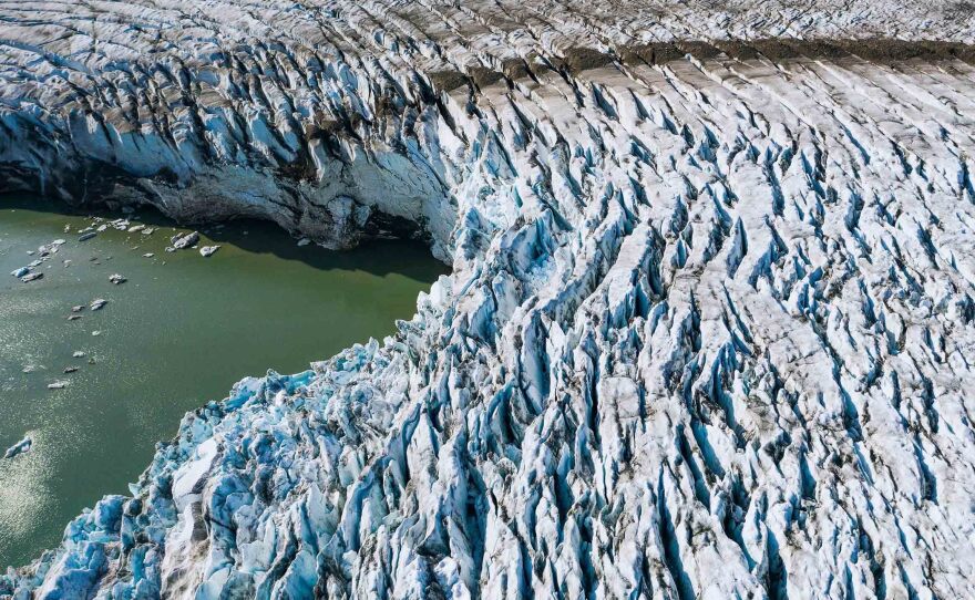 Greenland's melting ice is raising sea levels in coastal cities around the world. Limiting warming to 1.5 degrees Celsius could halve the amount oceans rise, compared with where they're headed now.