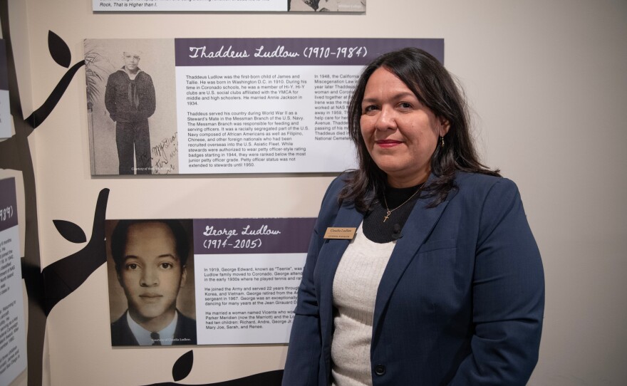 Claudia Ludlow stands in front of her family history at the Coronado Historical Association on Friday, Feb. 9 ,2024.