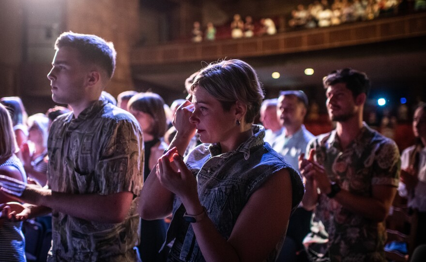 An audience member cries at the end of the second performance of "Cry of a Nation" at the Uzhhorod municipal theatre on July 17, 2022.