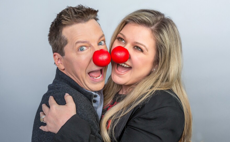 Sean Hayes and Kelly Clarkson wear red noses in support of Red Nose Day, a charity event that raises awareness for child poverty.