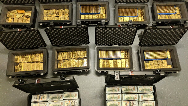 This image provided by U.S. Department of Justice, and contained in a court filing, shows gold bars and cash that was seized from a David J. Rush's home, during a search on May 19, 2026, in Ashburn, Va.