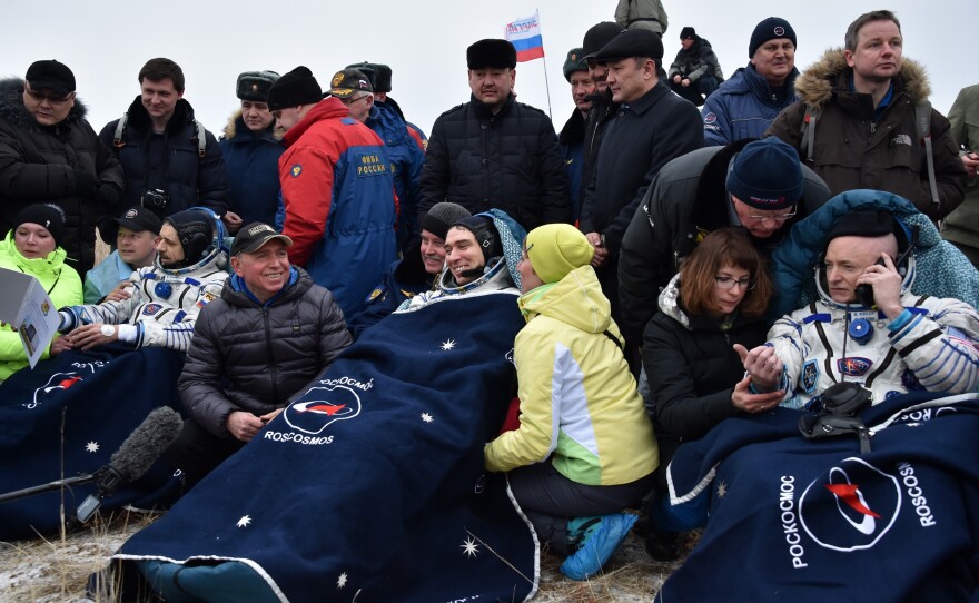 (From left) Russian cosmonauts Mikhail Kornienko and Sergei Volkov and U.S. astronaut Scott Kelly rest outside the space capsule after landing on Wednesday.