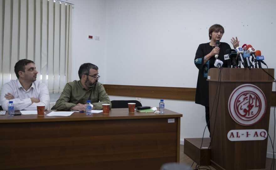 Ubai Aboudi, the head of Bisan Center (left), Addameer director Sahar Francis (right) and Tahseen Elayyan, from Al-Haq rights group hold a joint news conference in the West Bank city of Ramallah on Monday.