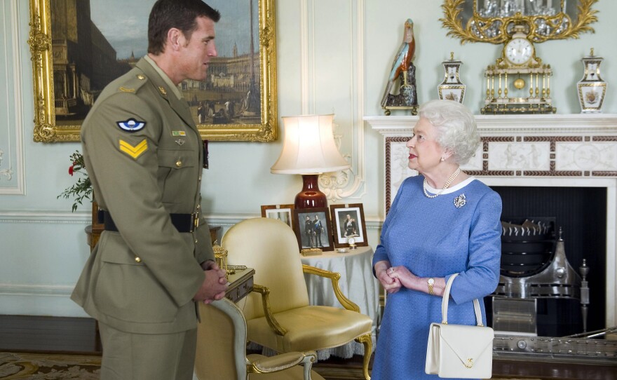 FILE - Britain's Queen Elizabeth II greets Corp. Ben Roberts-Smith from Australia, who was recently awarded the Victoria Cross, during an audience at Buckingham Palace in London, Nov. 15, 2011.