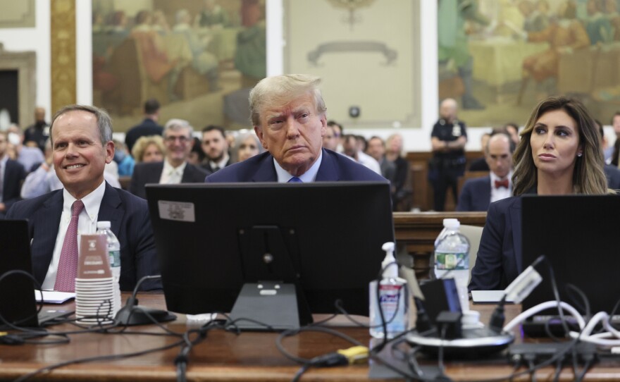 Former President Donald Trump (center) appears in court Monday in New York.