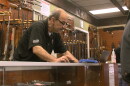 A customer looks at guns inside AO Sword Firearms in El Cajon, March 23, 2020.