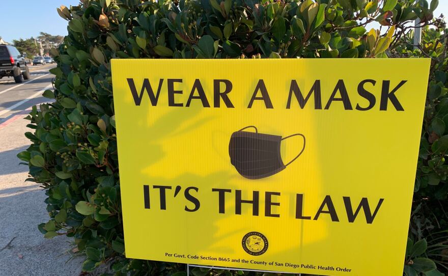 A sign advising visitors to wear a facial covering in Del Mar, Calif. Aug. 14, 2020.