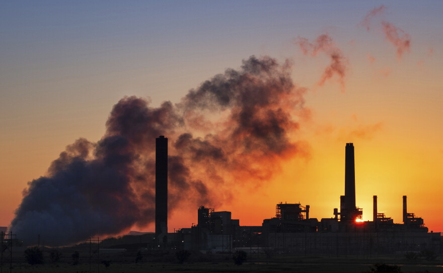 A coal-fired power plant is silhouetted against the morning sun on July 27, 2018, in Glenrock, Wyo. The EPA on Monday announced it's repealing limits on greenhouse gas emissions from fossil fuel-fired power plants.