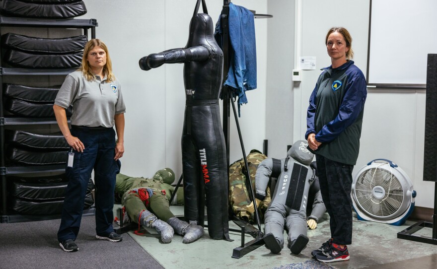 Recruit Nikki Acker and Training Officer Emily Samson in the Defense and Arrest Tactics (DAAT) room at the Madison Police Department training center.