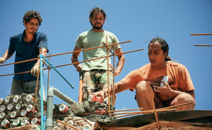 Enrique and members of Toki Music School constructing a new building with recyclable materials.