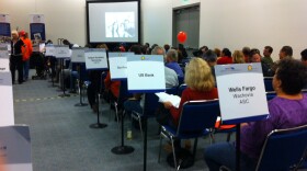 Homeowners watched presentations in a waiting room until a representative of their lender called their number.