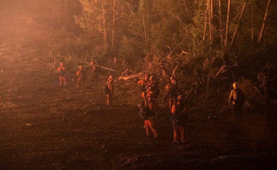 An inmate fire crew manages a backburn outside Calistoga, Thursday, Oct. 1, 2020.