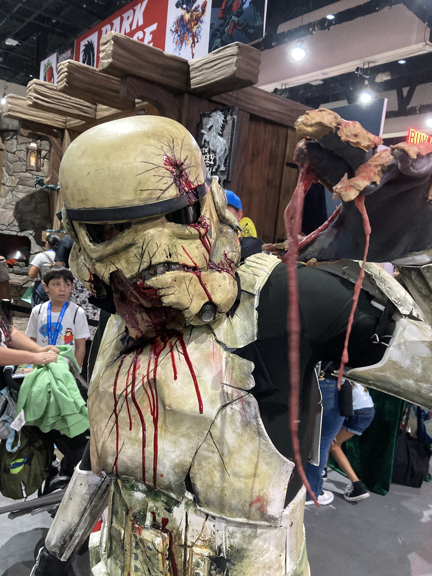 A cosplayer puts a gory twist on a classic look, portraying a bloodied and battle-damaged stormtrooper holding up his own guts at Comic-Con on July 26, 2025.
