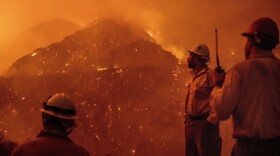 Firefighters monitor the Thomas fire as it burns through Los Padres National Forest near Ojai, Calif., Dec. 8, 2017. 