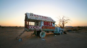 The truck where outsider artist Leonard Knight sleeps. It's painted in the same style as his monumental work, Salvation Mountain. 
