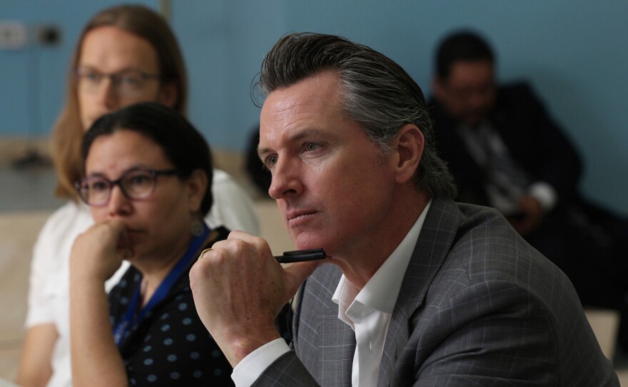 California Gov. Gavin Newsom listens to rehabilitation experiences made by non-governmental organizations made in favor of Salvadoran gang members, during a meeting at the Divina Providencia Hospital facility in San Salvador, El Salvador, Tuesday, April 9, 2019.
