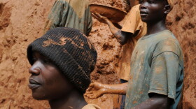 Gold miners stand on a muddy cliff as they work at a northeastern Congo mine in February 2009. Activists want the U.S. government to identify militia-controlled mines in the Congo. That way, critics say, businesses will have to be responsible for their supply chains.