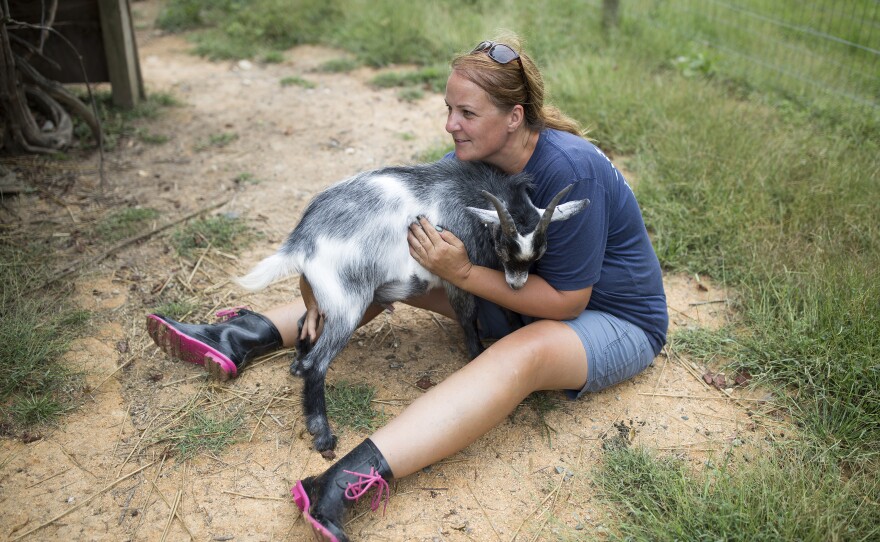 Payne gives Oreo the goat a hug.