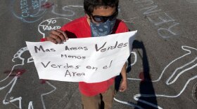 A demonstrator protests the arrival of Mexican President Felipe Calderon in Ciudad Juarez on Feb. 17. He holds a sign reading, "More green areas, less greens in the area" (referring to soldiers). Calderon arrived in the city for the second time in less than a week to meet with local and state authorities to address a security crisis after a group of gunmen attacked a party Jan. 31, killing 15 teens and injuring many others.
