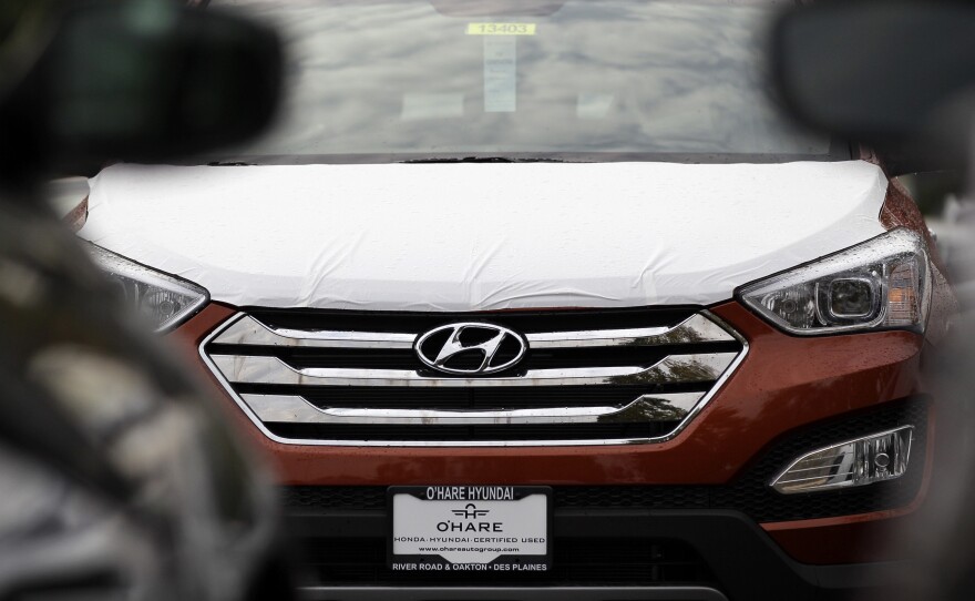 A Hyundai Sonata sits in a Hyundai car dealership in Des Plaines, Ill., in 2012. U.S. auto safety regulators have stepped up a series of investigations into engine fires that have plagued Hyundai and Kia vehicles for more than six years.