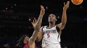San Diego State guard Lamont Butler shoots over Florida Atlantic guard Alijah Martin during the second half of a Final Four college basketball game in the NCAA Tournament on Saturday, April 1, 2023, in Houston.