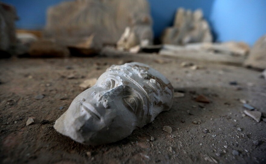 The face of a statue lies on the ground at the destroyed museum in the ancient Syrian city of Palmyra on March 31.