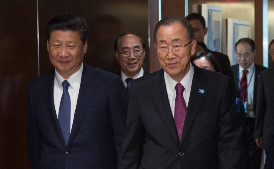 Chinese President Xi Jinping, left walks with United Nations Secretary General Ban Ki-moon, on Saturday at U.N. headquarters in New York. At a U.N. conference, Xi pledged billions in Chinese aid to developing nations.