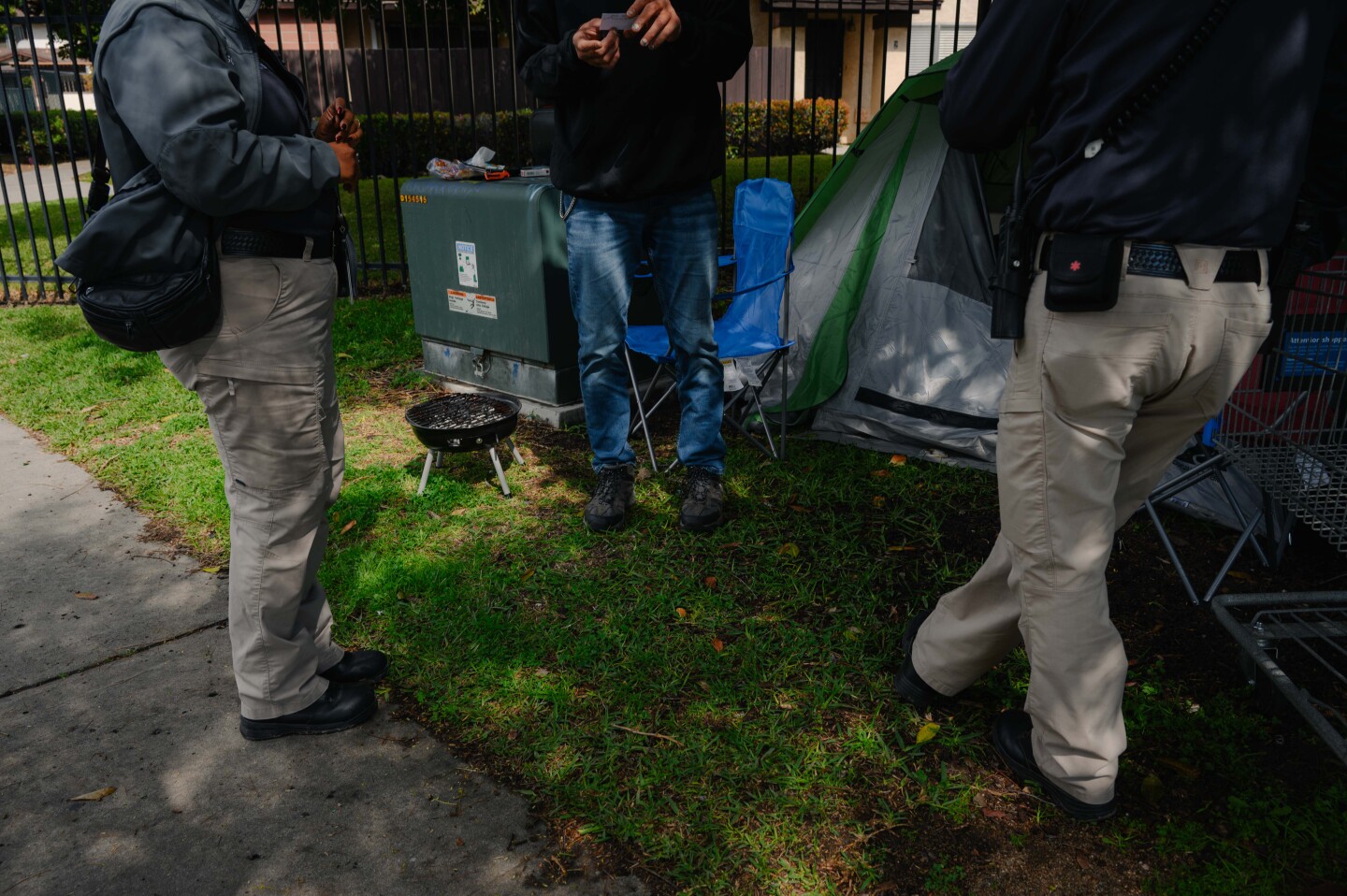 Qiana Williamson and Hector Hueso, the two members of National City’s HOME team, speak with a resident experiencing homelessness on March 7, 2024.