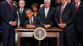 President Obama signs the financial reform bill into law, July 21, 2010. Vice President Joe Biden, Senate Majority Leader Harry Reid (D-NV), then Senate Banking Chairman Christopher Dodd (D-CT), House Financial Services Committee Chairman Barney Frank (D-MA) and other lawmakers look on.