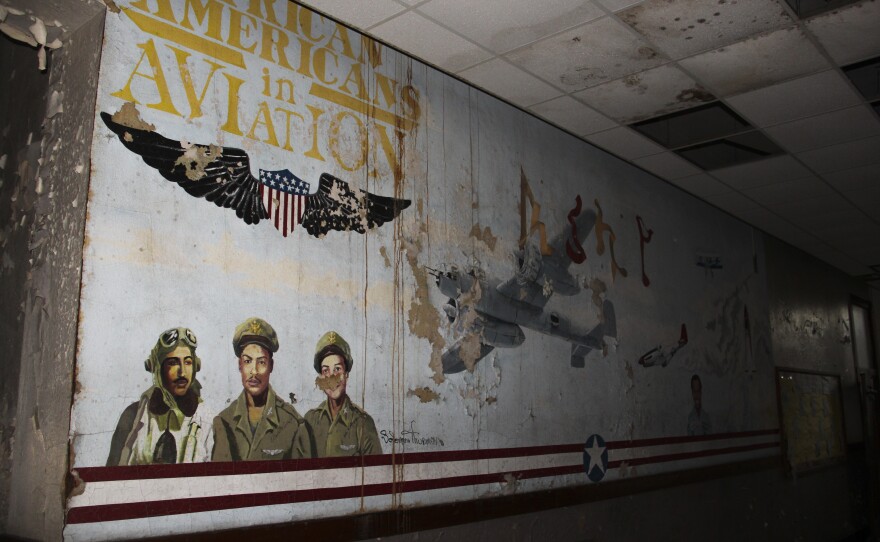 The Eliot building is falling apart, but hints of the past still line the surface — like this old mural visible through the peeling paint.