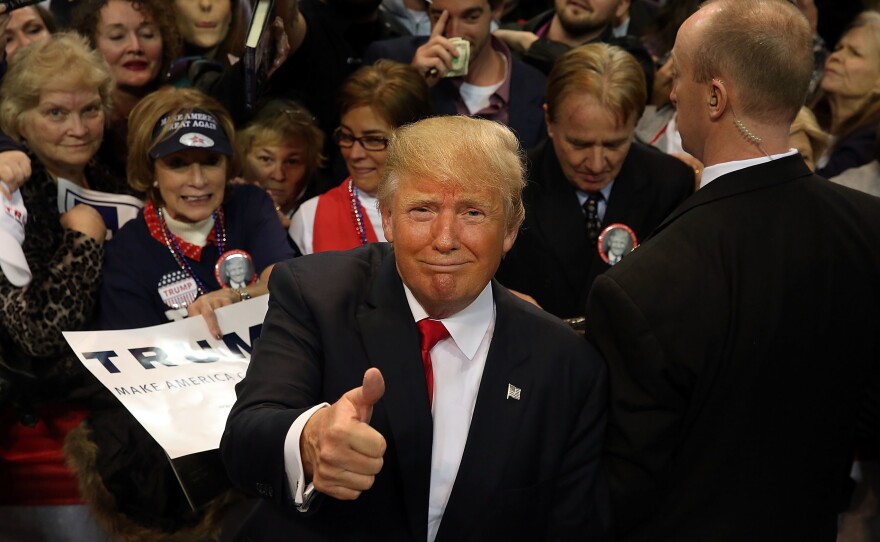 Trump pauses with supporters after speaking at the Mississippi Coast Coliseum on January 2, 2016 in Biloxi, Mississippi.