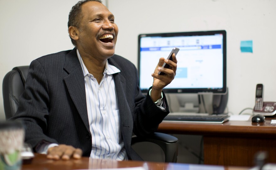 Omar Shekhey has a laugh while fielding questions and phone calls at the Somali American Community Center in Clarkston, Ga. Shekhey, who runs the nonprofit group, has been helping Clarkston's refugee community for several years though the center and an after-school program.
