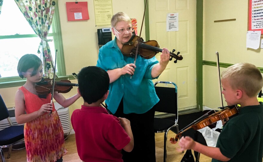 (From left to right) Mackenzie Stamper, Adrian Rodriguez and Luke Ryan attend weekly Suzuki violin lessons with instructor Sara Johnson, part of a training program called MILEStone, or Music Impacting Language Expertise.