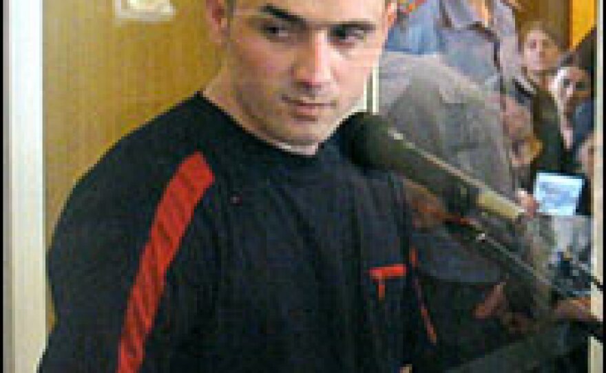 Nurpashi Kulayev, left, the only Beslan hostage taker to be captured alive, stands in the defendant's cage during his trial in Vladikavkaz, Russia, May 26, 2006. He was sentenced to life in prison. The judge said that only a ban on capital punishment prevented Kulayev from being executed.