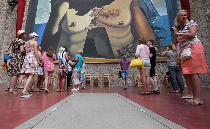 Tourists visit Salvador Dali's tomb at the Dali Museum Theater in Figueres on Friday, following the exhumation of his remains.