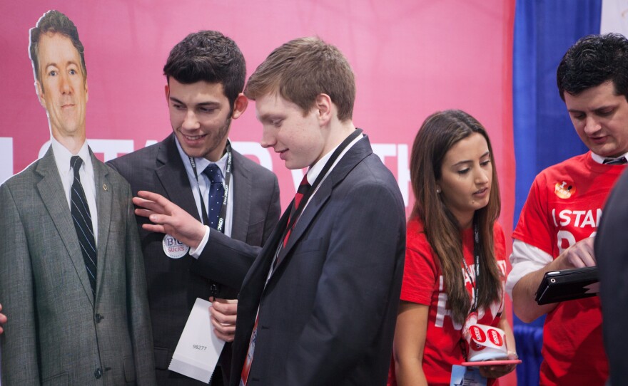 Josh DiNatale, left, and Zachary Burns, St. Joseph's University students and members of their College Republicans chapter, get ready to pose for a photo with a cutout of Sen. Rand Paul at CPAC 2015.