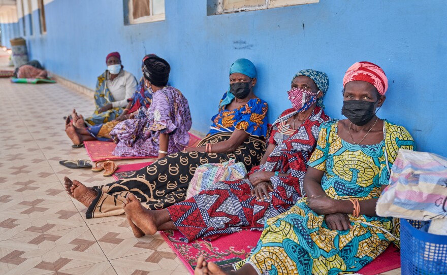 People in protective masks wait in the corridor of a hospital in Bunia, Congo, Tuesday, May 19, 2026.