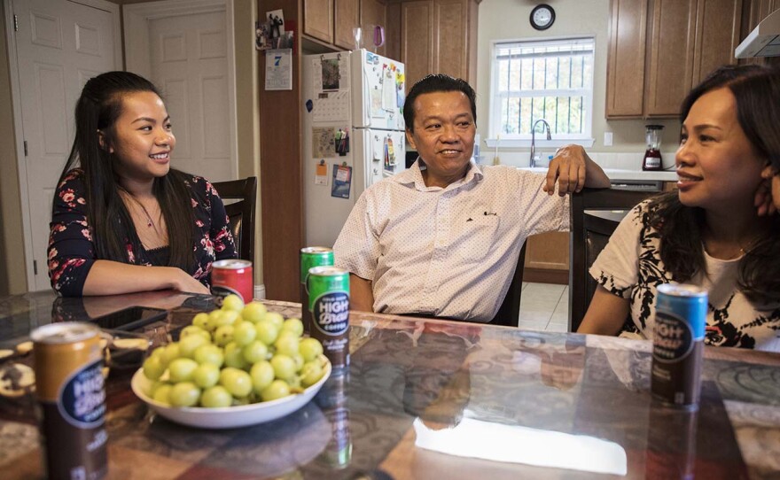 Jenny Nguyen, with her parents Khanh Nguyen and Tammy Vo, sitting in their home in Sacramento built by Habitat for Humanity in this undated photo. 