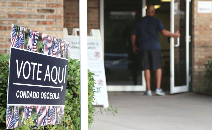A voter enters an Osceola County polling station during early voting in the federal election in Kissimee, Florida on October 25, 2016.