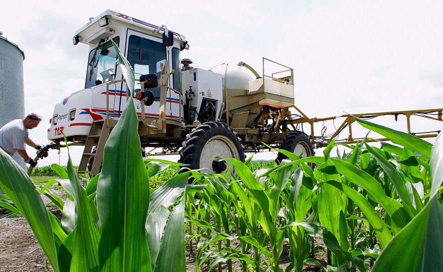 A central Illinois corn farmer refills his sprayer with the weedkiller glyphosate on a farm near Auburn, Ill. The pesticide has been the subject of intense international scrutiny.