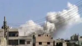 An image grab taken from a video uploaded on YouTube Feb. 5, 2012 shows smoke billowing from the Baba Amr neighborhood after shells were fired in the flashpoint Syrian city of Homs.