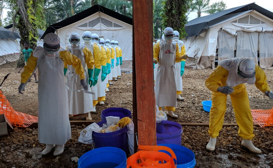 Health workers remove their protective suits at a treatment center set up by Doctors without Borders in Mangina, a town in the Democratic Republic of Congo.