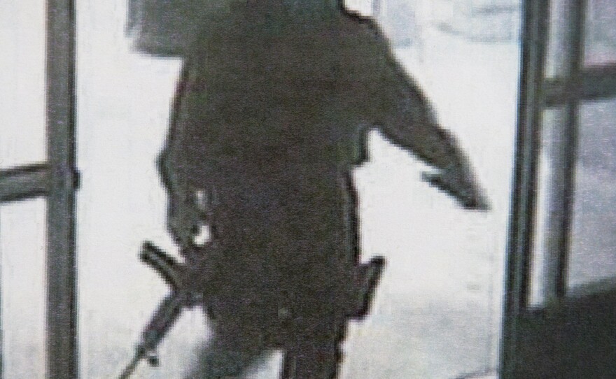 This photo provided by the Santa Monica Police Department during a news conference Saturday, June 8, 2013, shows a frame grab from a surveillance camera revealing the suspect entering Santa Monica College on Friday.