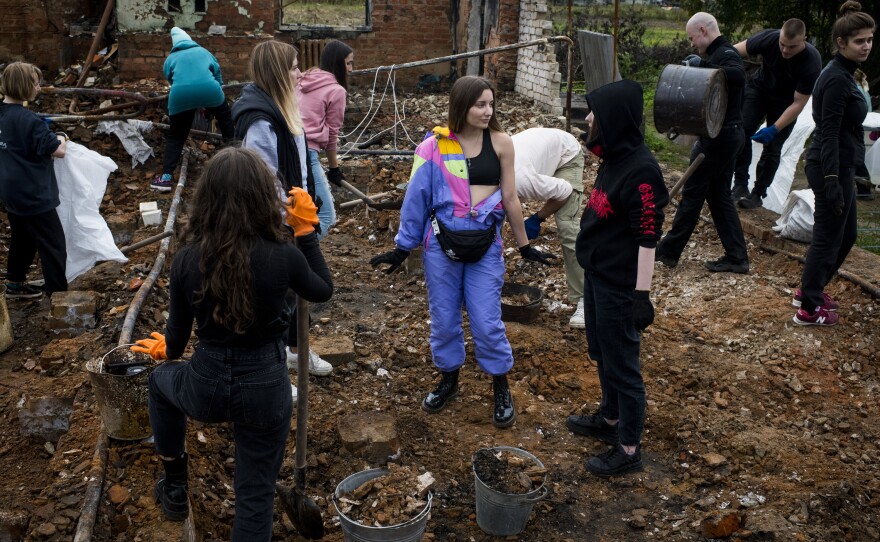 Repair Together volunteers clean up the home of Hanna Yurchenko in Kolychivka, Ukraine.