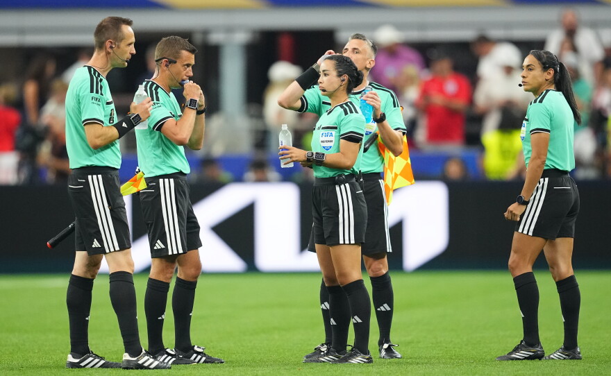 Referees takes a hydration break during the World Cup Group L soccer match between England and Croatia in Arlington, Texas, near Dallas, Wednesday, June 17, 2026.