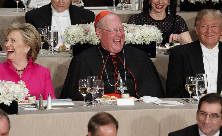 Democratic presidential candidate Hillary Clinton, Cardinal Timothy Dolan and Republican presidential candidate Donald Trump laugh during Thursday's Al Smith Dinner at the Waldorf Astoria New York hotel.