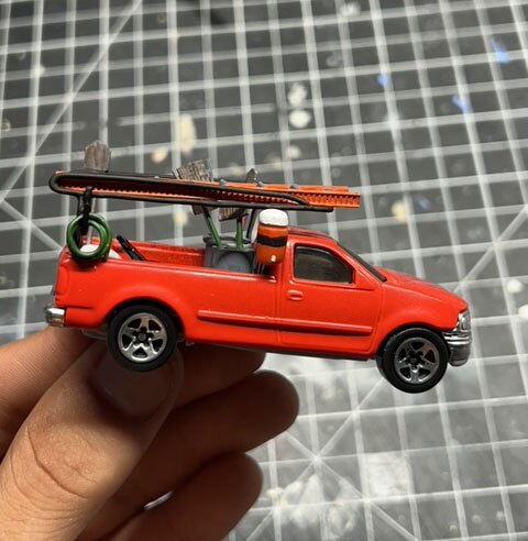 Marino Gomez's landscaping truck art toy is shown during construction, customized from an old Hot Wheels toy.