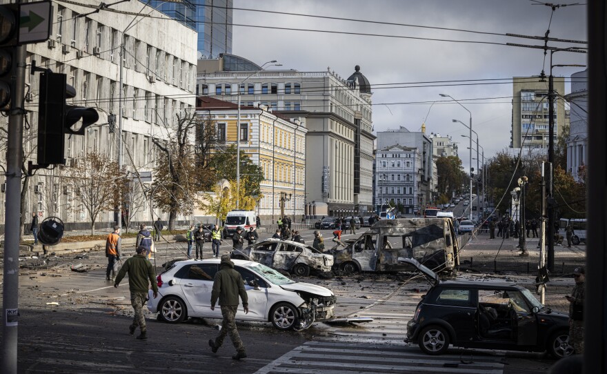 Emergency service personnel attend to the site of a blast on in Kyiv on Monday.