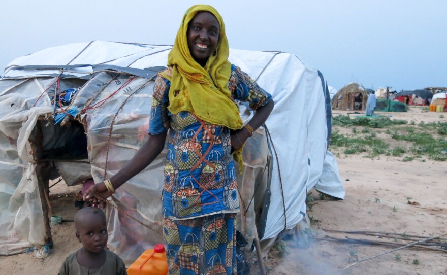 Kaltume Abubakar, displaced by Boko Haram fighting, cooks the evening meal for her family of four — son, daughter, husband and mother-in-law, outside her makeshift home at the informal Muna camp, near Maiduguri, northeastern Nigeria.