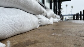 A business in Ocean Beach prepared for Tropical Storm Hilary by lining up sand bags, Aug. 20, 2023.
